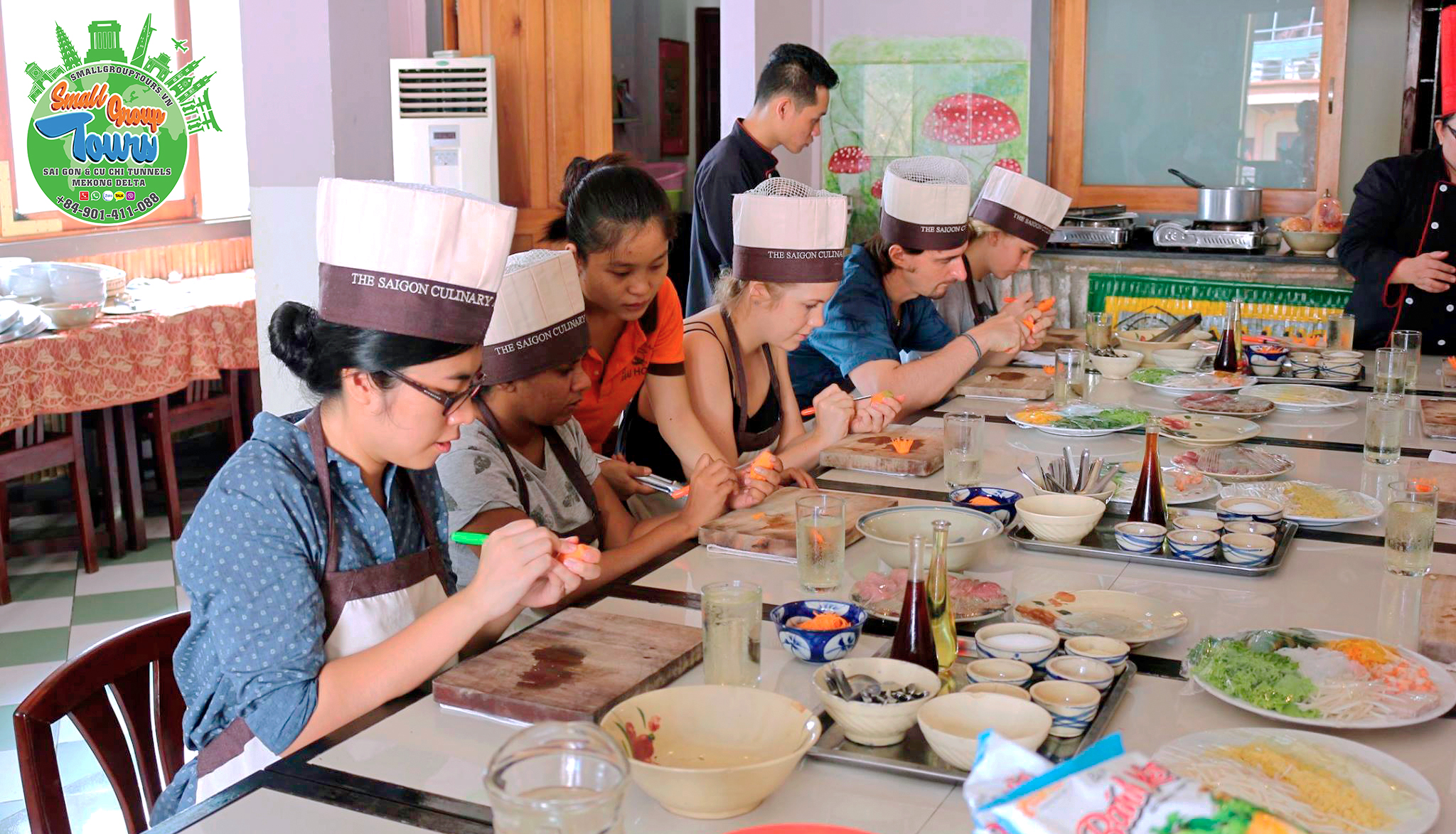 Tourists engage in hands-on practice, carving intricate decorations from carrots with expert guidance from our cooking class staff.